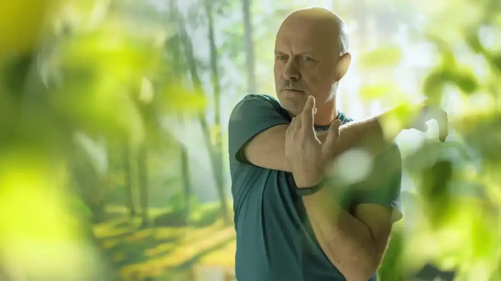 middle aged man stretching arms in the nature