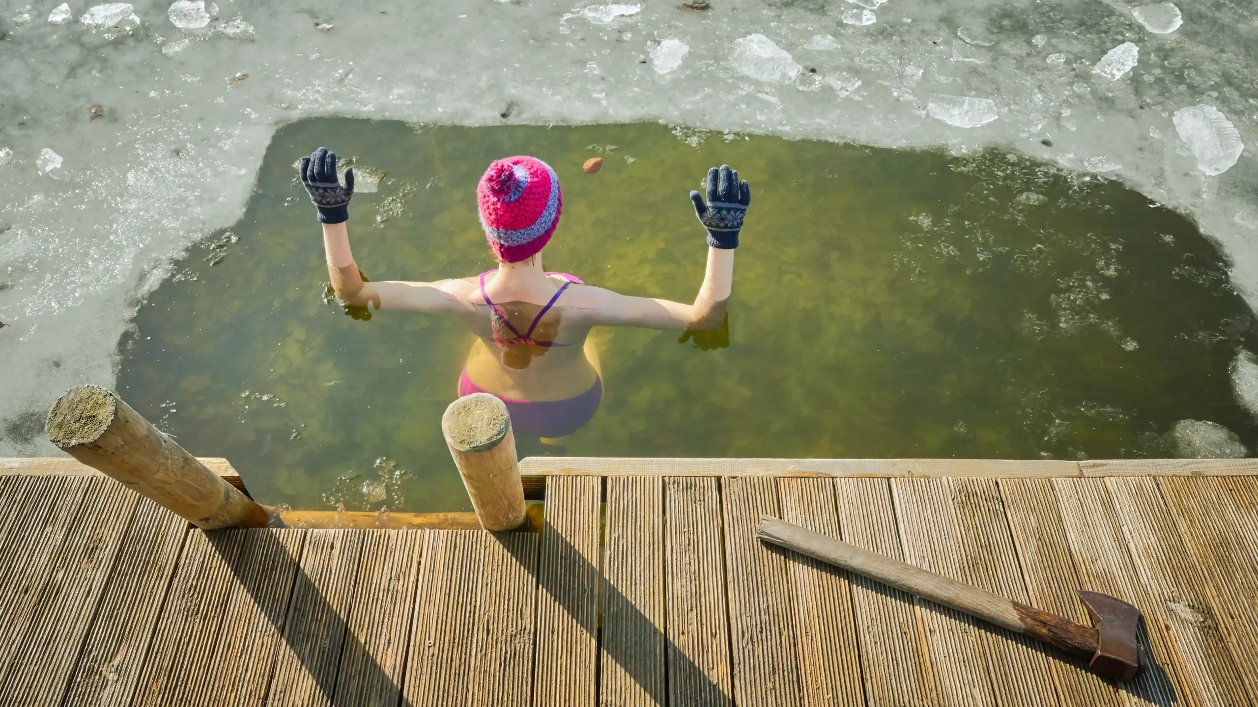woman taking a dip in cold lake