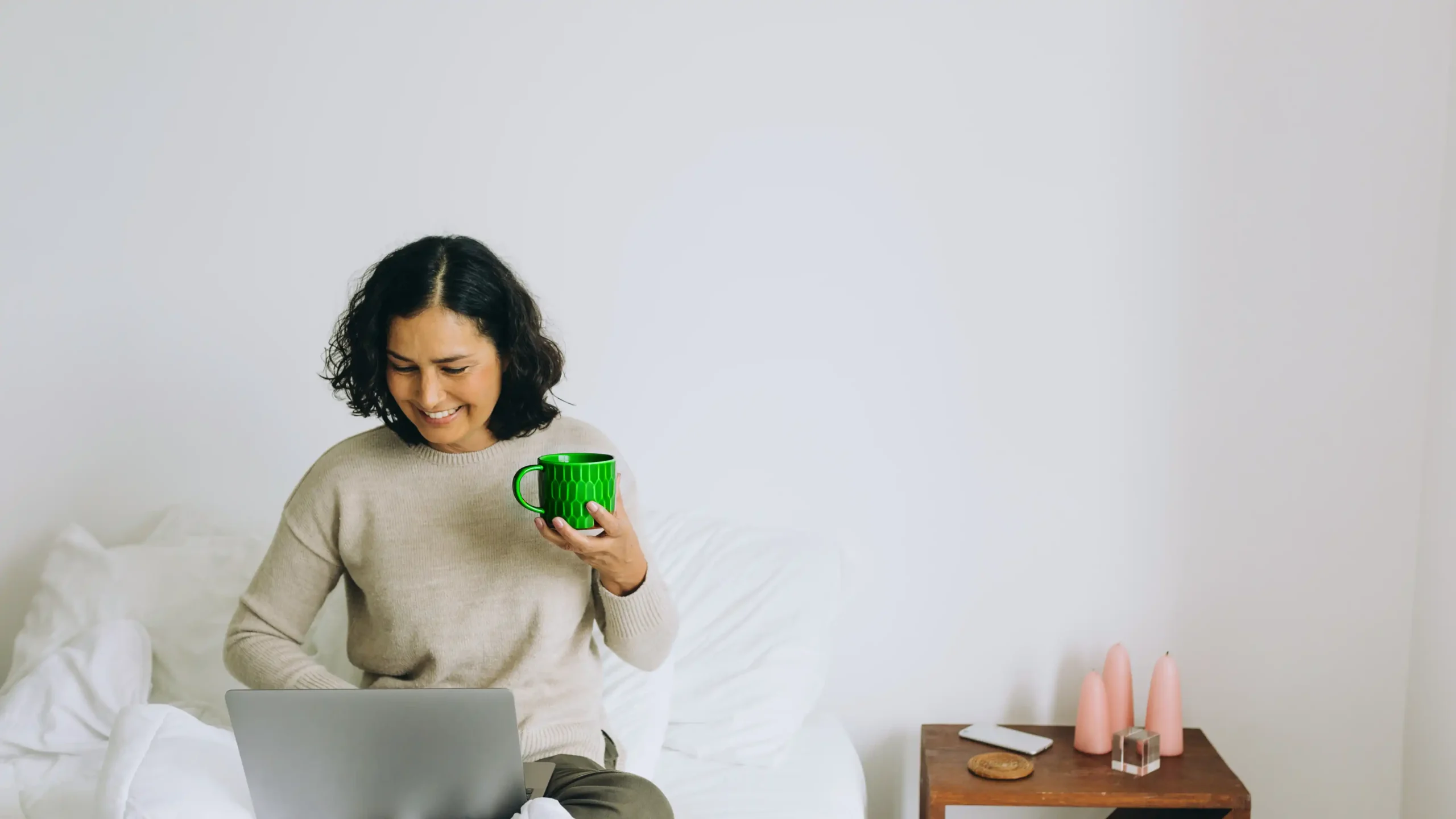 woman working on the laptop while drinking tea