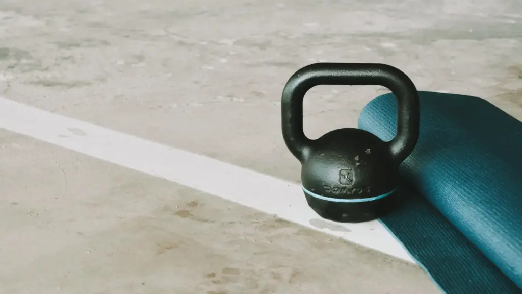 yoga mat and dumbbell on the ground