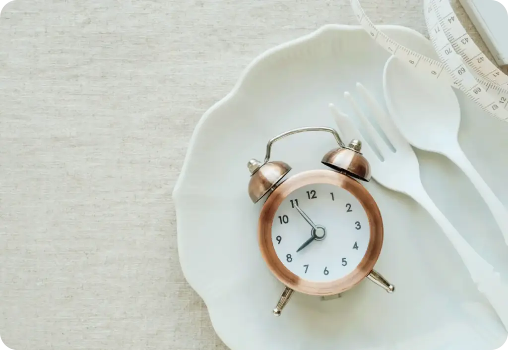 measuring tape, fork and alarm clock displayed on the plate