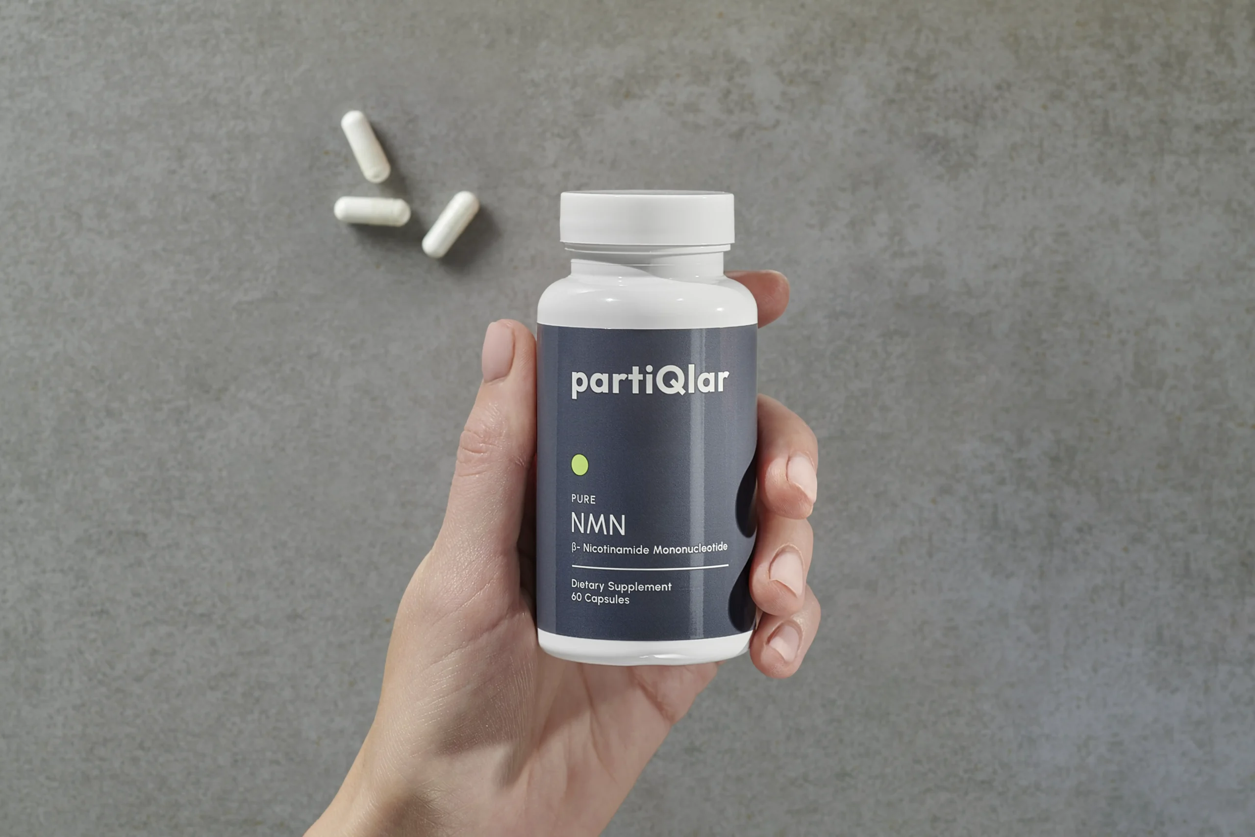 woman holding partiqlar nmn supplements in hand