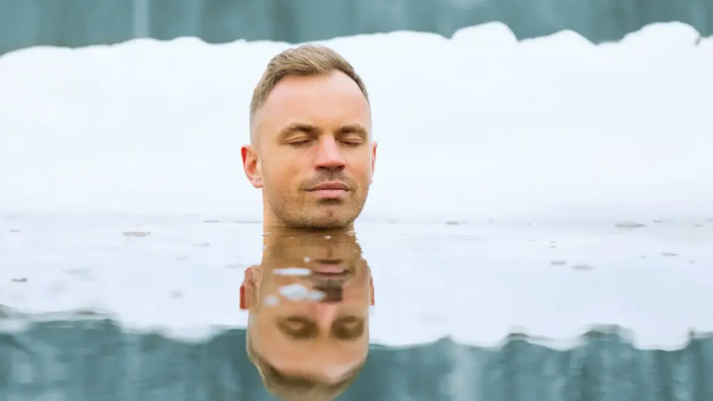 man swimming in the cold lake