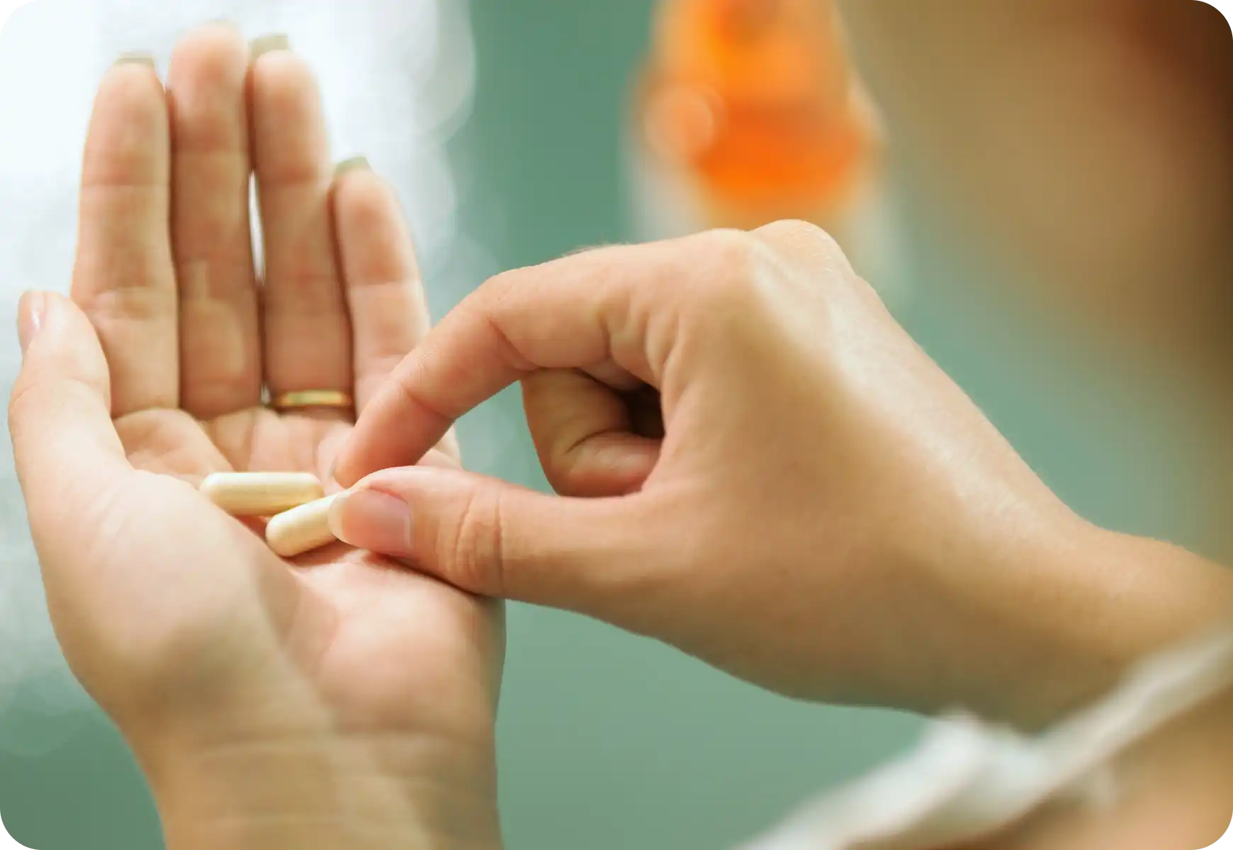 woman holding supplements in her hand