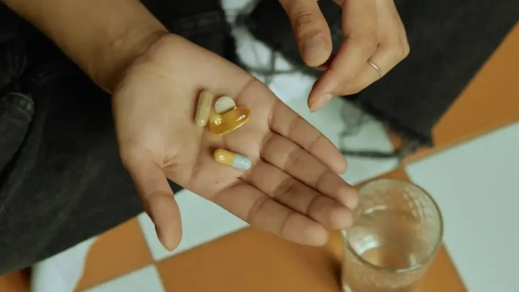 woman holding supplements in her hand