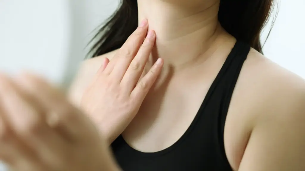 A woman examining her neckline and skin