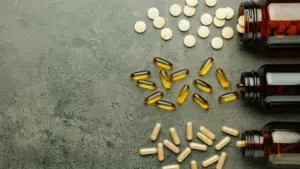 Three different supplement bottles placed neatly on a table.